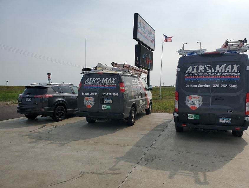 Three air max vans are parked in a parking lot.