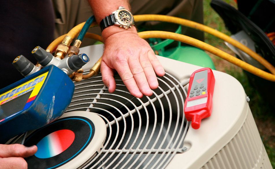 A man wearing a watch is working on an air conditioner