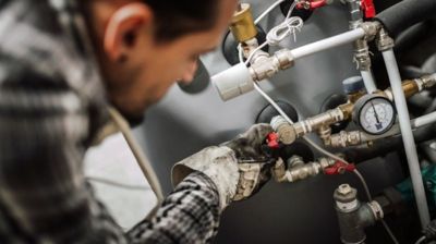 A man is working on a machine in a factory.