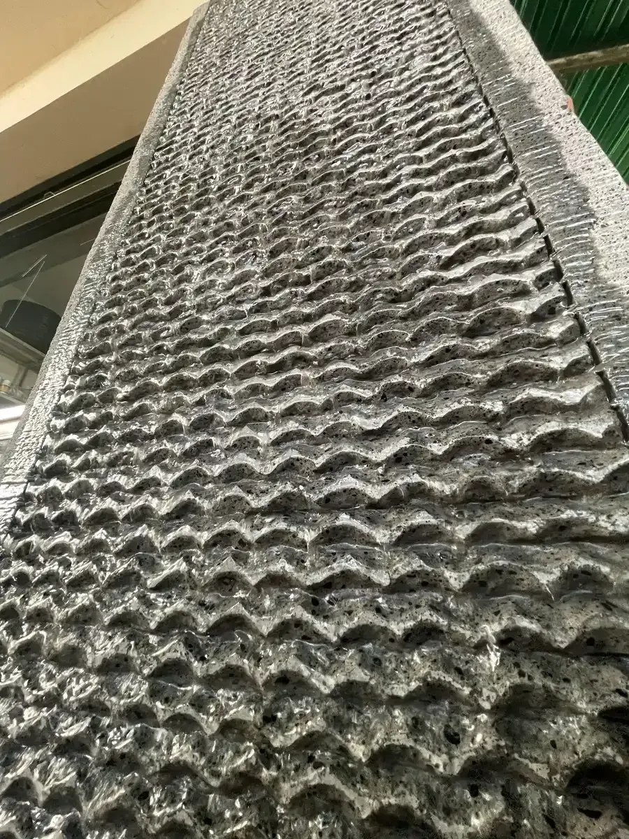 Un primer plano de una superficie de piedra con un patrón en ella donde el agua corre sobre ella.