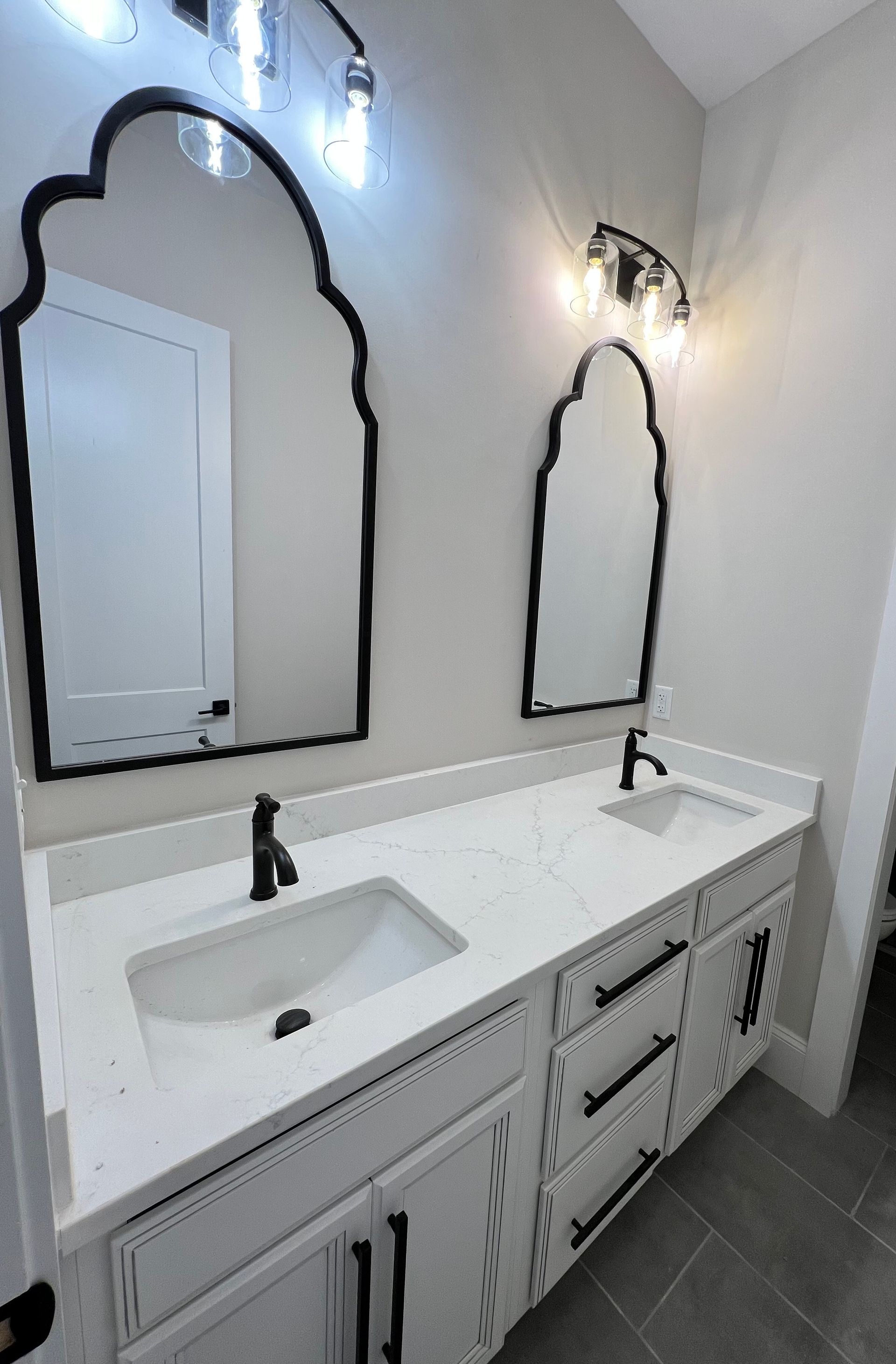 Bathroom renovation in progress with exposed plumbing pipes in a trench.