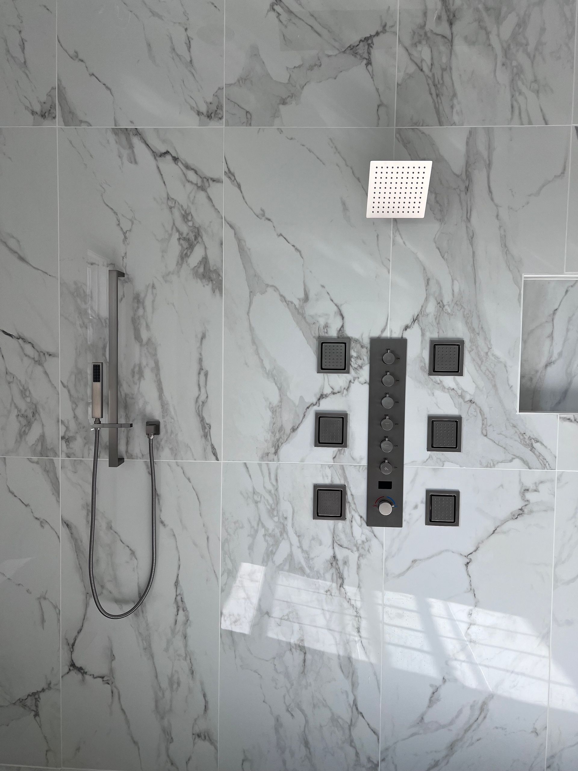 Construction site with exposed plumbing and framing for a bathroom renovation.