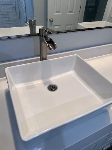 White rectangular sink with a chrome faucet.