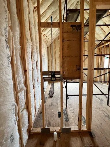 Interior of a building under construction. Wood framing with insulation in the walls.
