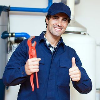 Plumber holding a wrench — Plumbing Service & Repair in Newton, MA