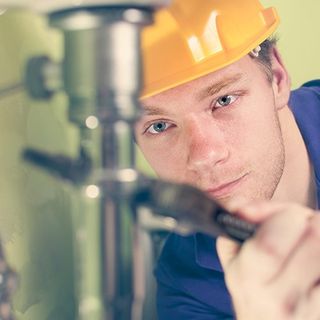 Plumber repairing a sink — Plumbing Contractors in Newton, MA