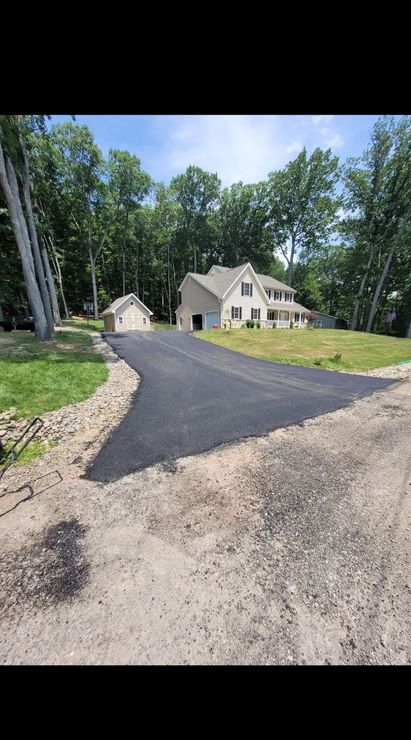 Freshly paved black asphalt driveway installed by Z&S Construction LLC at a residential property in Berwick, Pennsylvania.