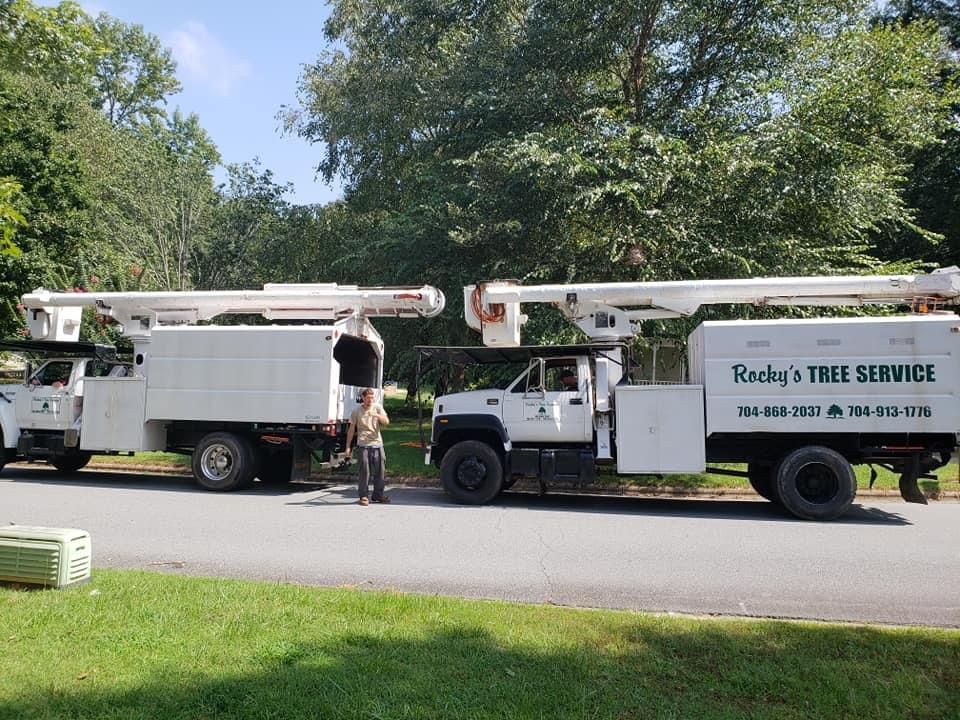 Two Tree Service Trucks Are Parked Next To Each Other On The Side Of The Road — Gastonia, NC — Rocky's Tree Service