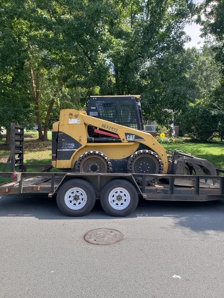 A Bulldozer Is On A Trailer Parked On The Side Of The Road — Gastonia, NC — Rocky's Tree Service