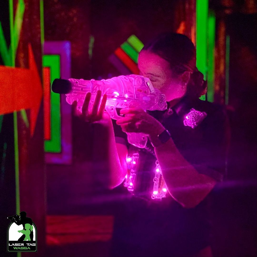 A Girl Playing A Laser tag with a laser gun in a dark room — Laser Tag Wagga In Wagga Wagga, NSW