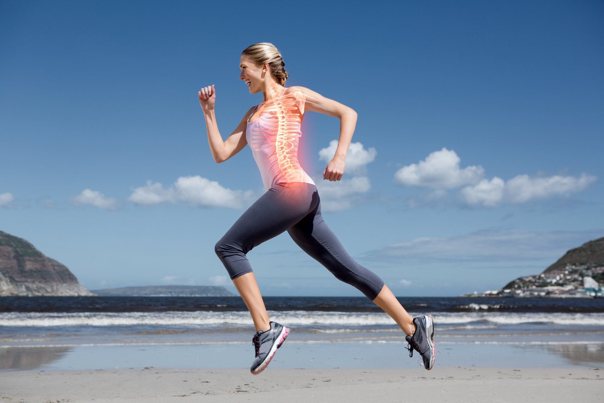 Woman running on beach — Chiropractor in Mackay, QLD