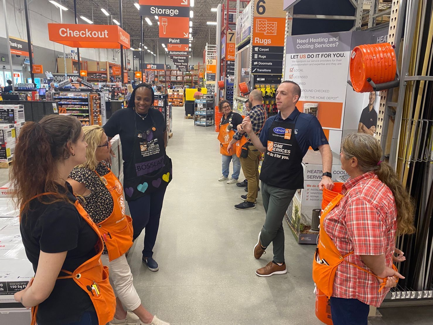A group of Ebens Air Conditioning Employees standing in a Home Depot store talking to each other.