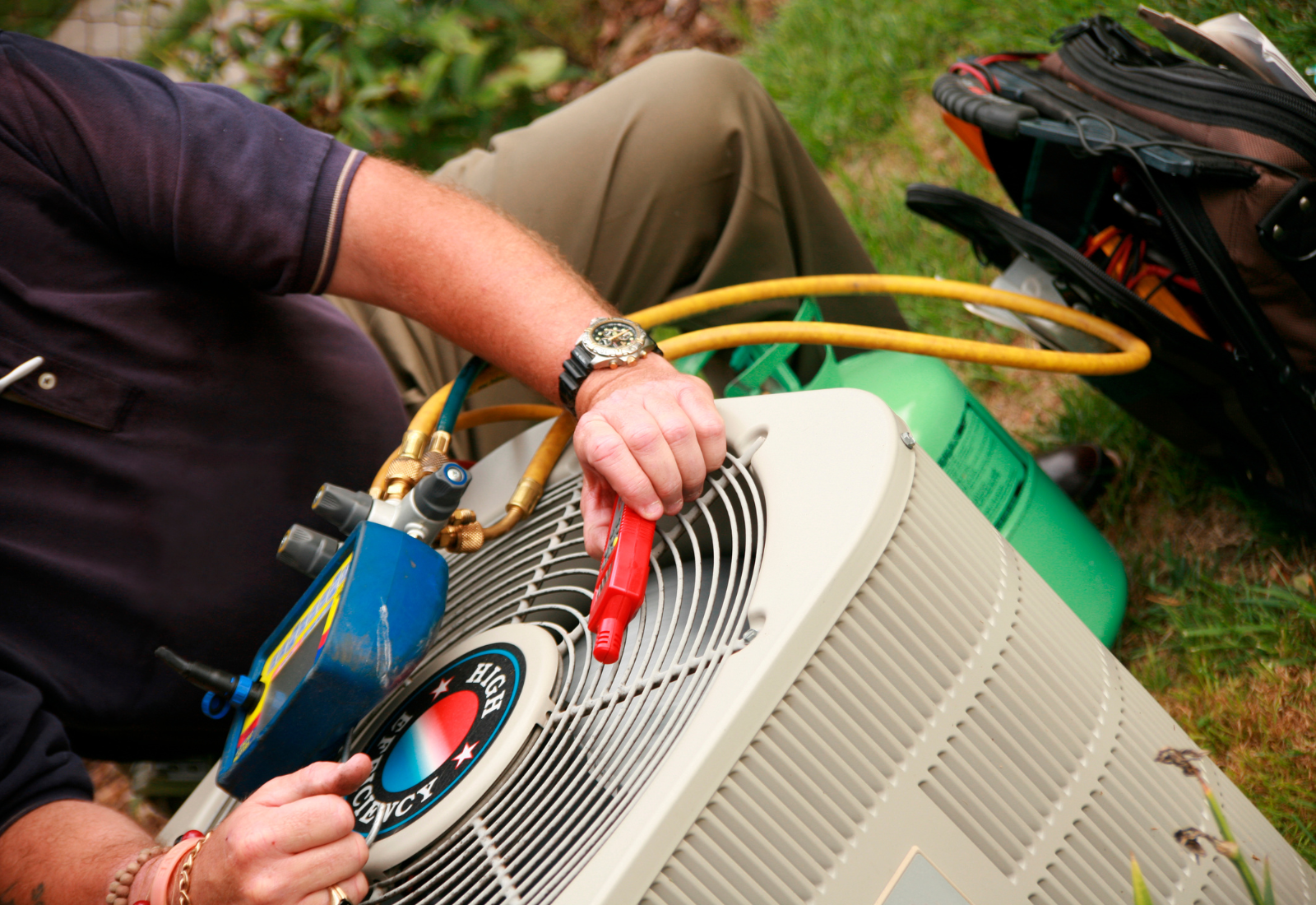 AC technician servicing an air conditioning system