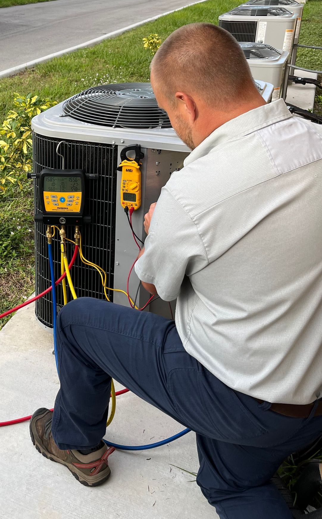 Ebens Air Conditioning & Plumbing Service Technician working on an Air Conditioner.