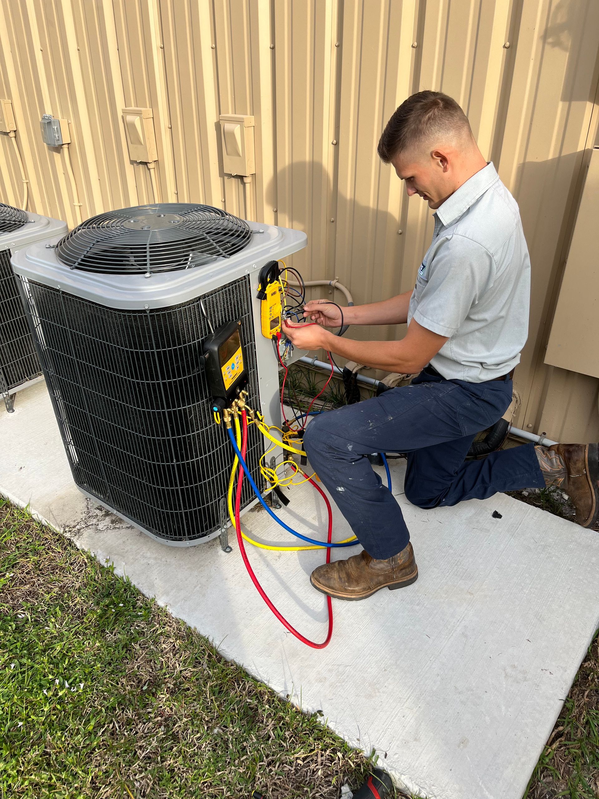 HVAC tech repairing an air conditioning unit