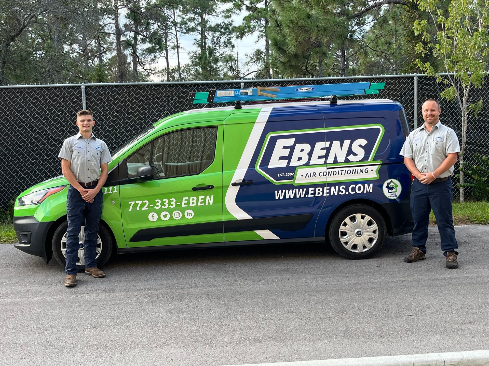Ebens HVAC technicians standing next to service vehicle