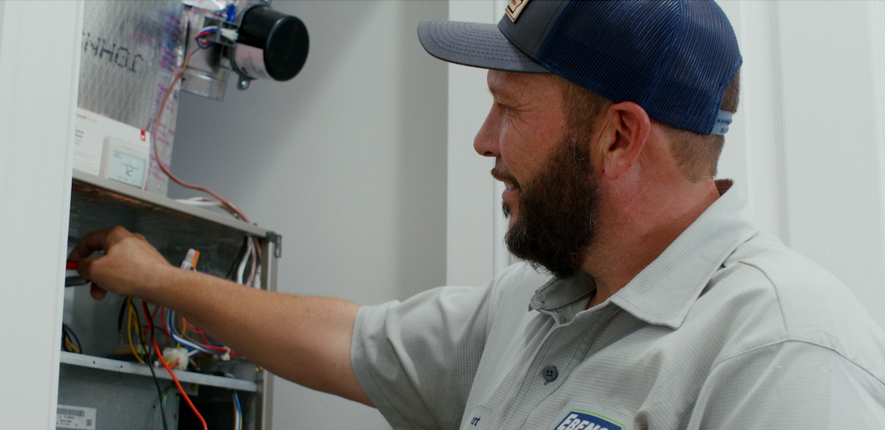 AC technician servicing an air conditioning system