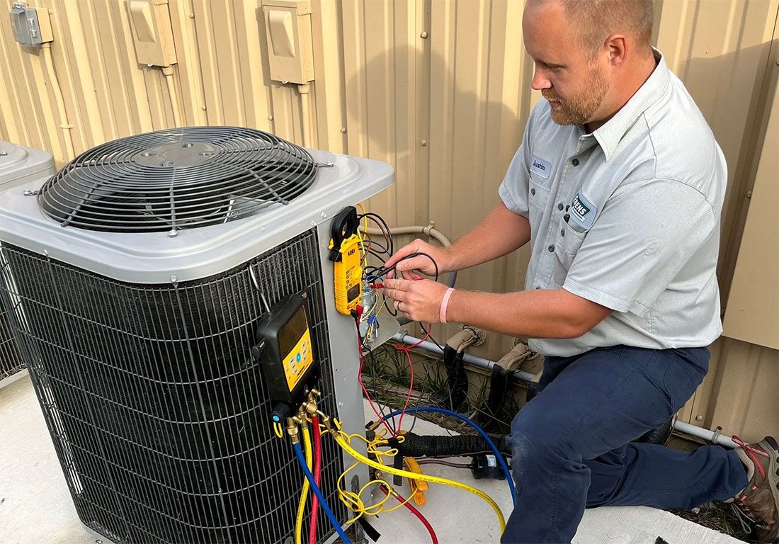 AC Technician from Ebens inspecting a residential air conditioning unit