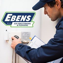 A plumber repairing a water heater in Jensen Beach