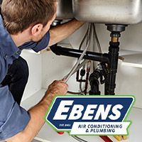 Plumber repairing a kitchen sink drain at a home in Port St. Lucie, FL