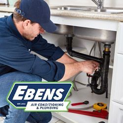 Plumber repairing a kitchen sink drain