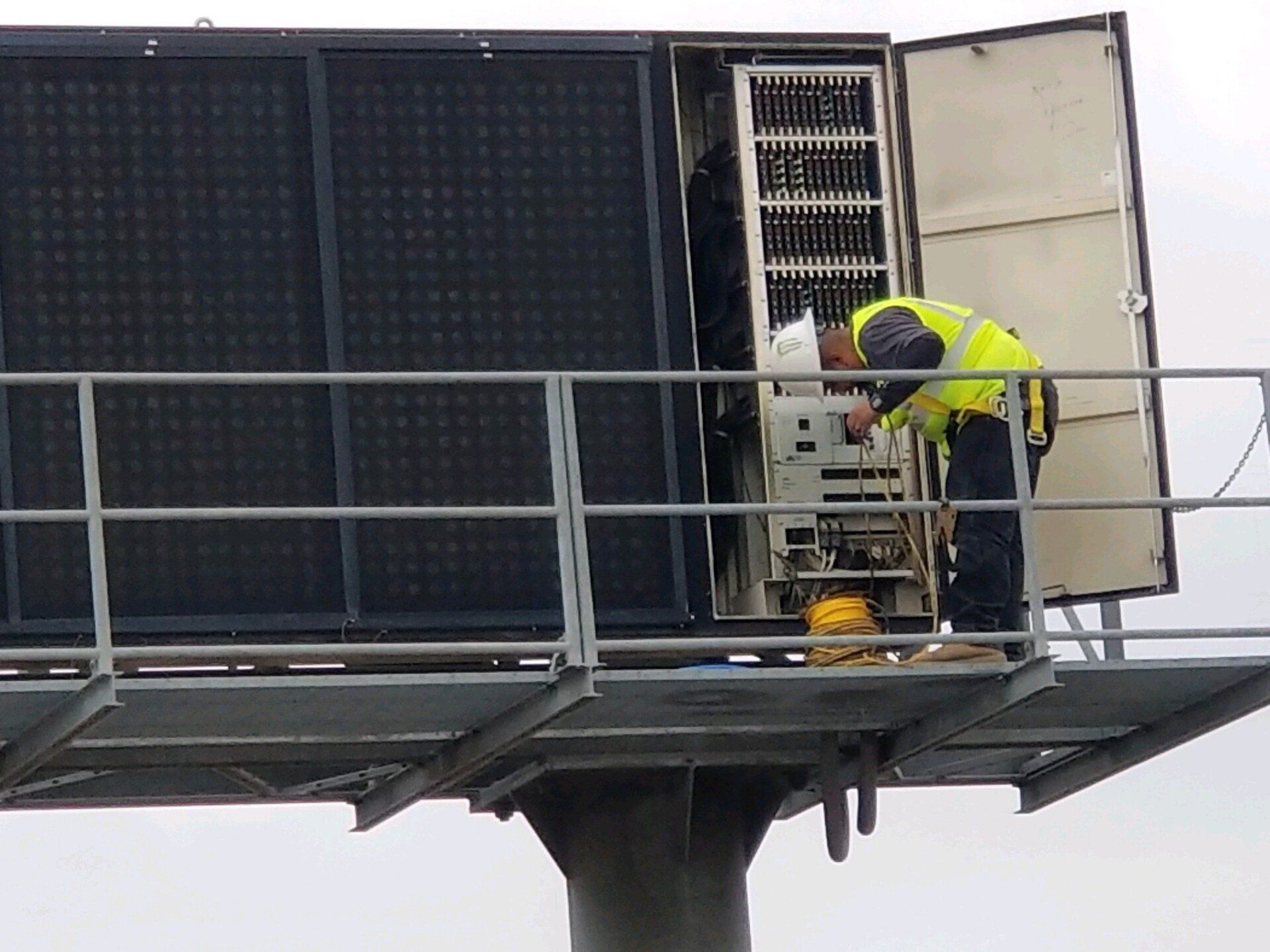A man repairing a changeable message sign — Beaumont, CA — M. Brey Electric, Inc