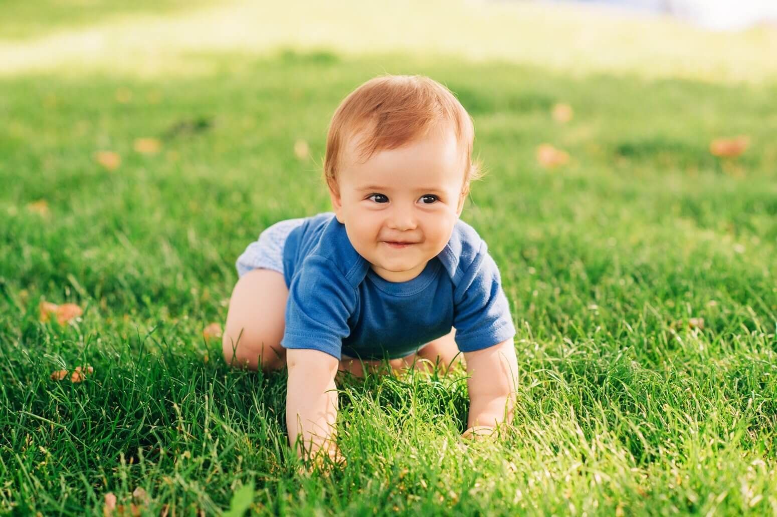 Baby crawling on the grass