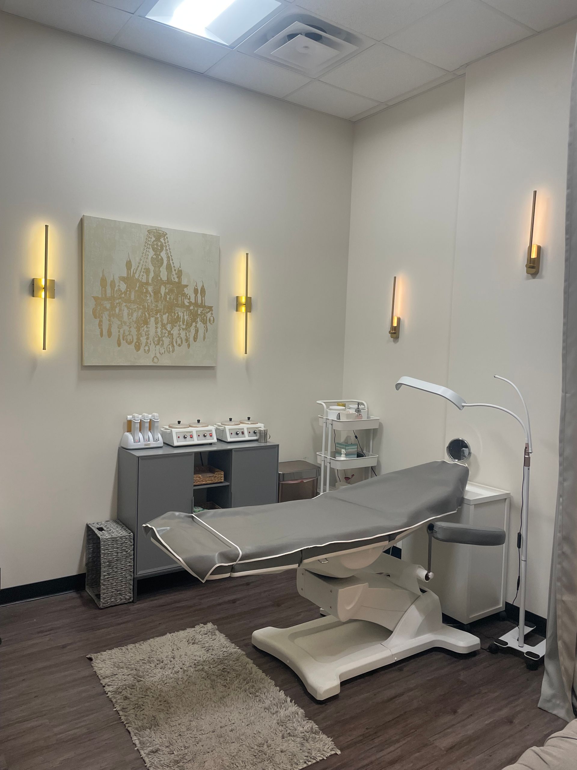 There is a painting on the wall above the bed in the room.