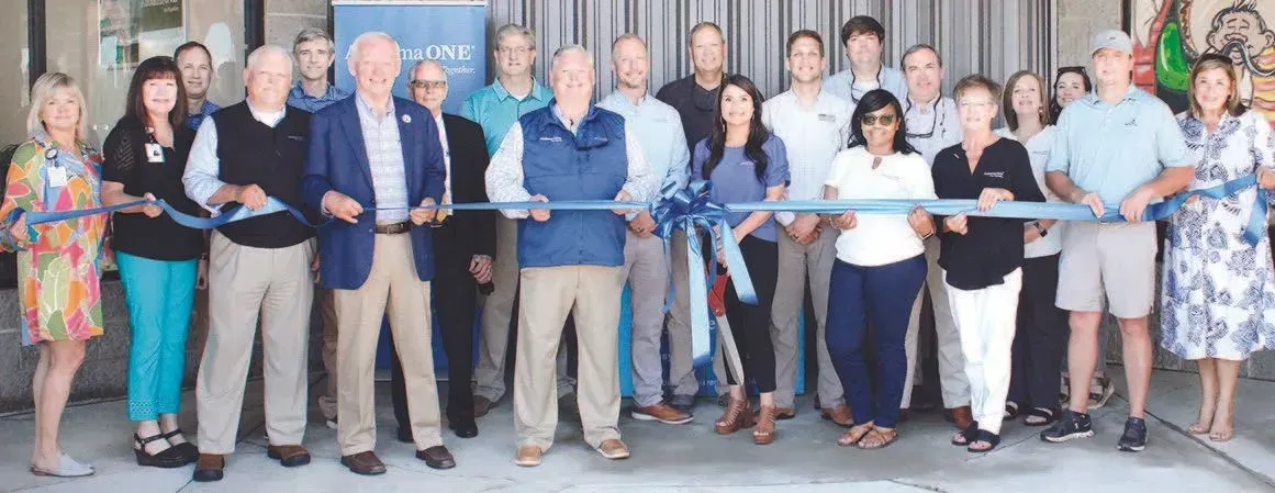 A group of people are standing next to each other holding ribbons.