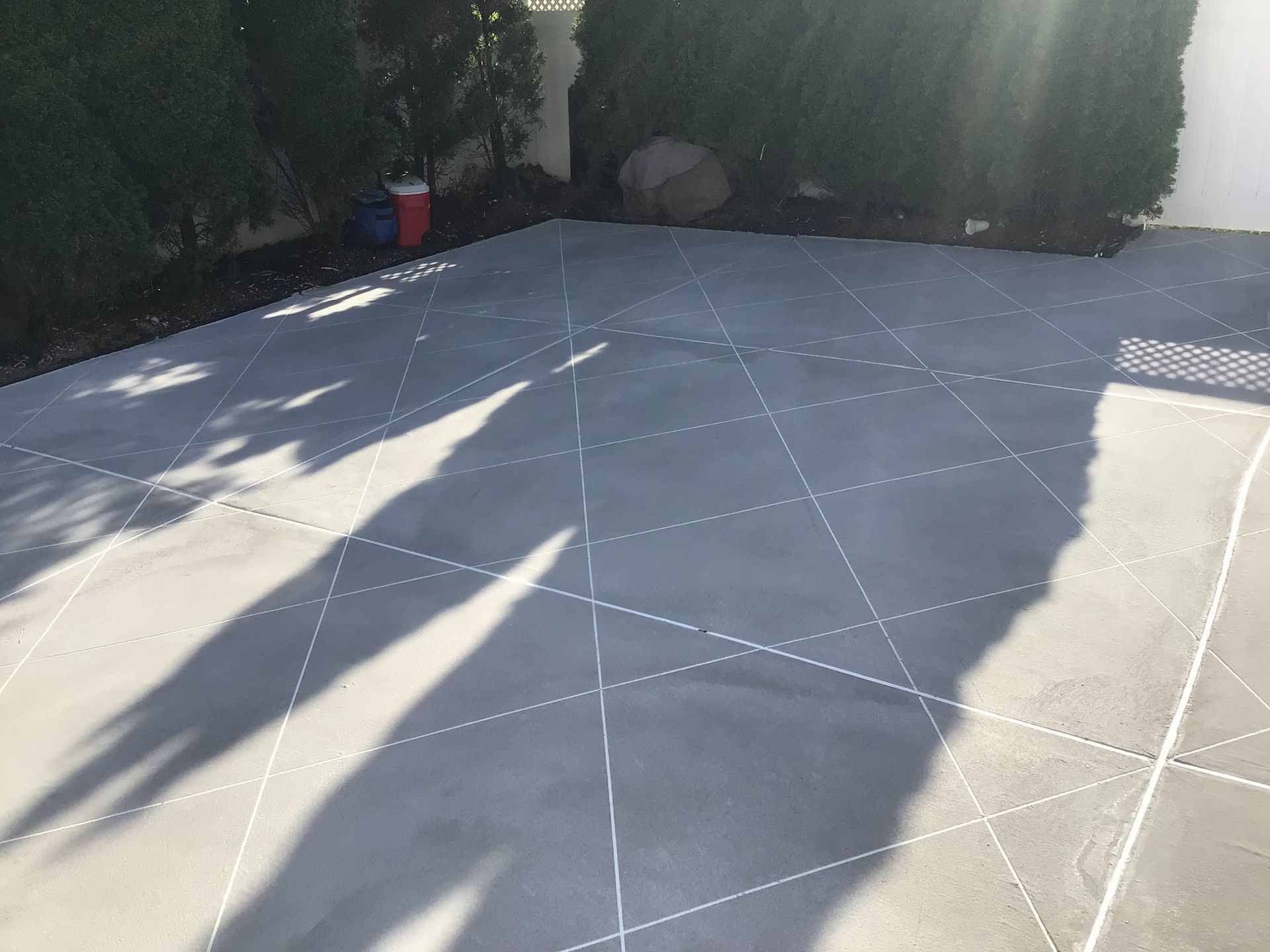 A shadow of a person is cast on a concrete floor.