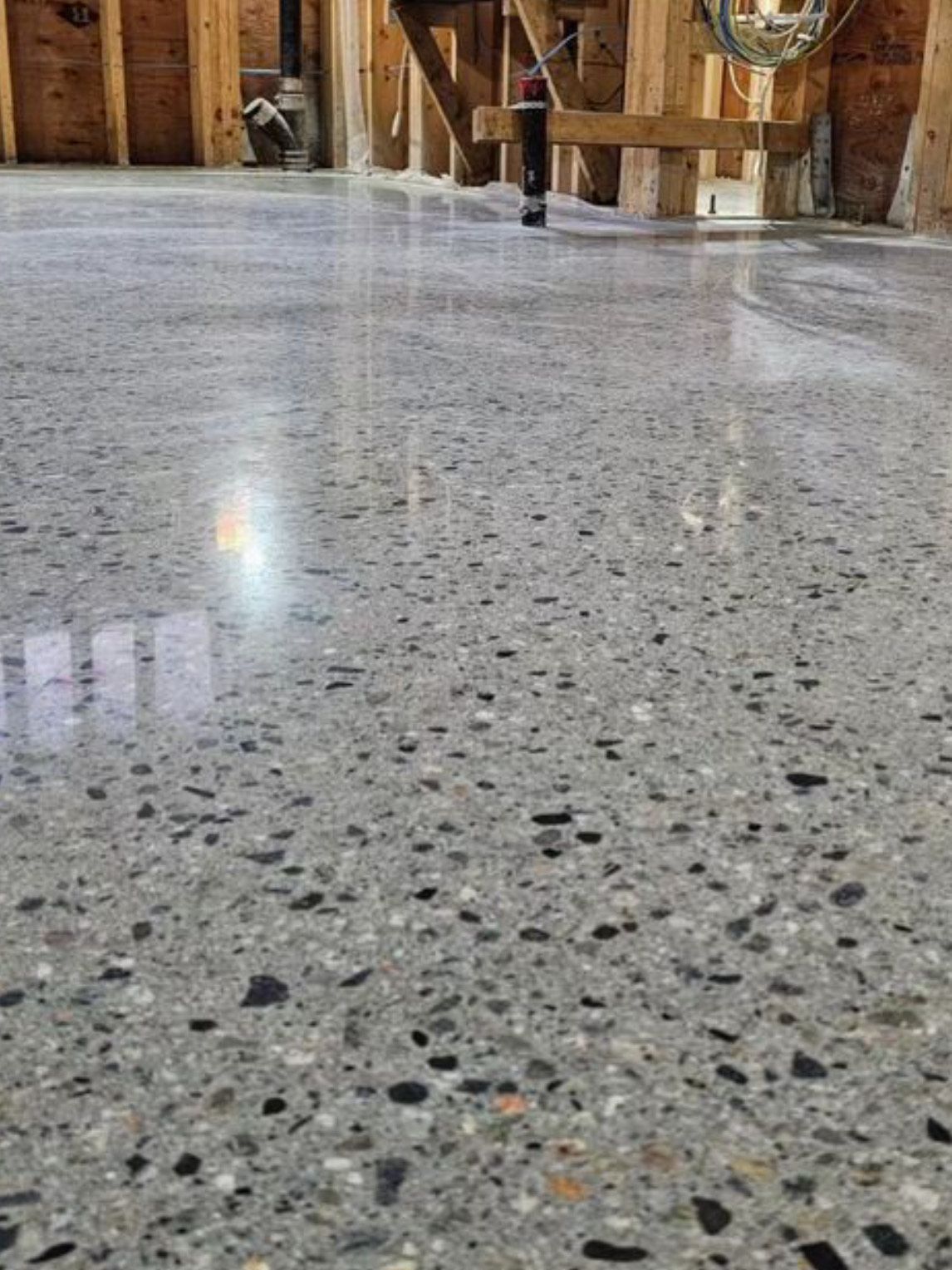 A close up of a concrete floor in a building under construction.