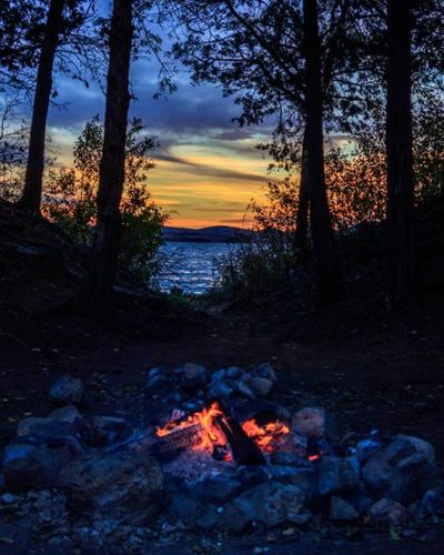 Firepit by lake at sunset | Rent Lawton