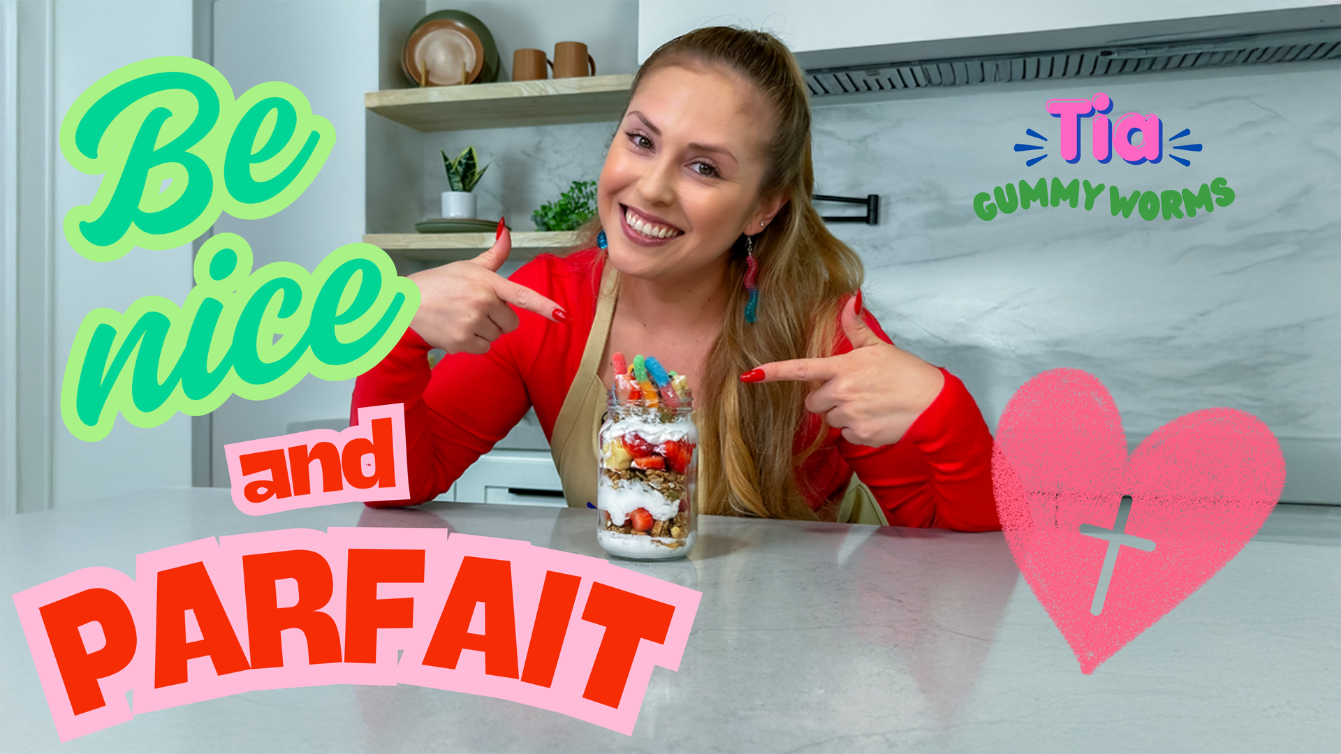 Tia GummyWorms pointing at a fruit parfait with the text “Be Nice and Parfait.