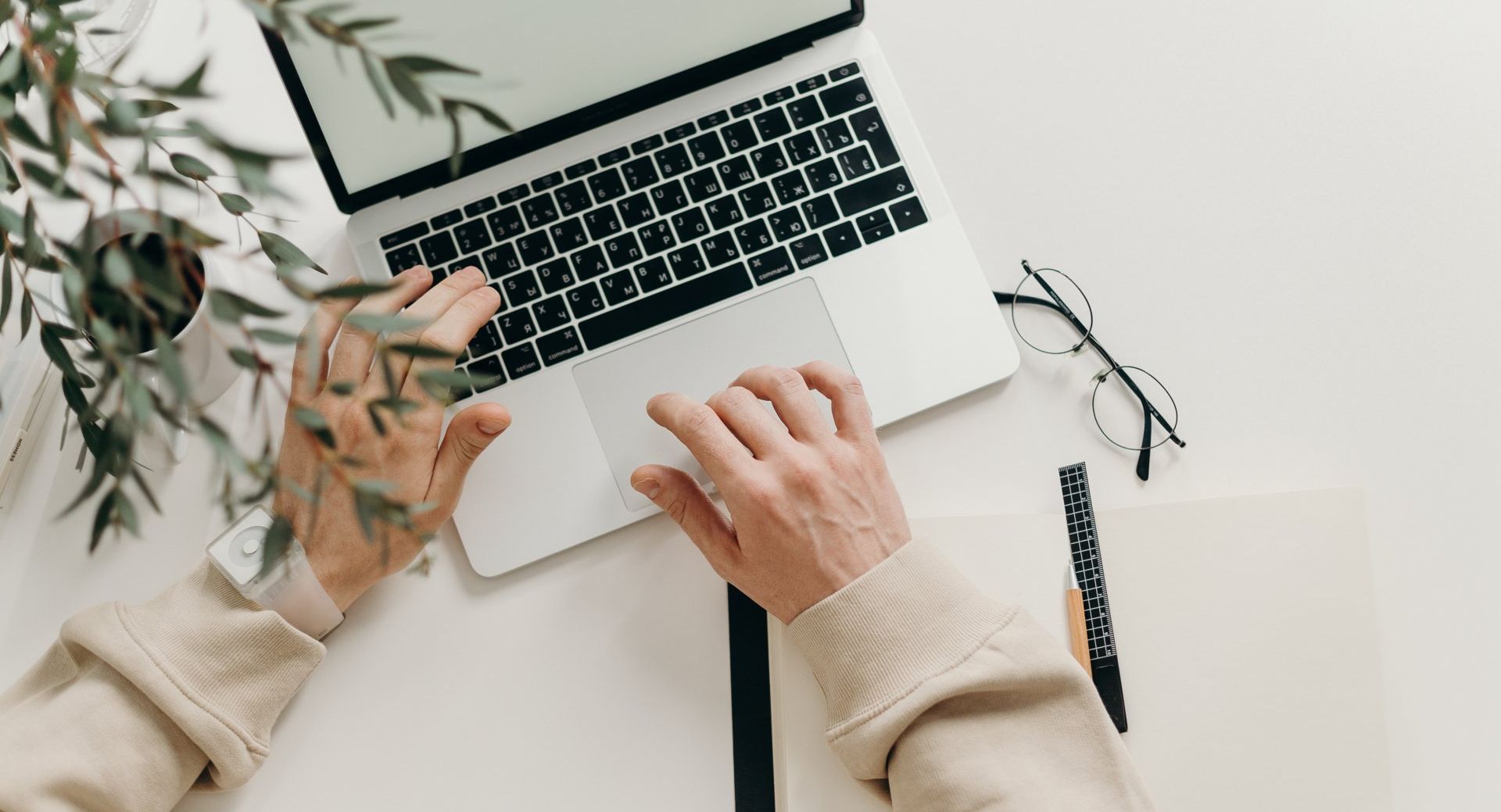 Virtual Assistant typing as they work on a laptop for their client.