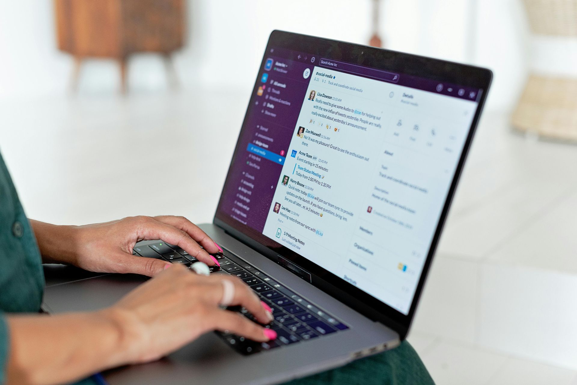A Virtual Assistant is sitting at a table using a laptop computer.