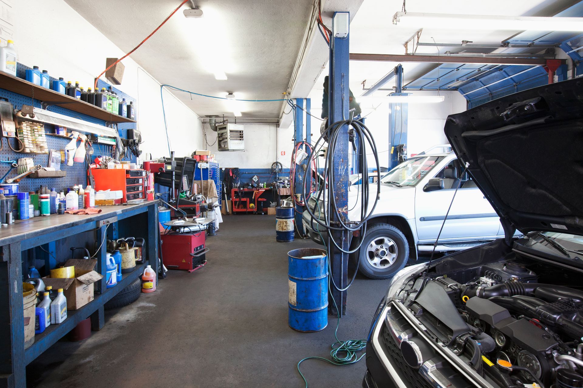 A car in a garage with the hood open