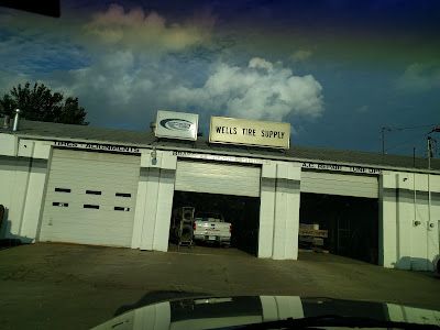 A car is parked in front of a tire shop