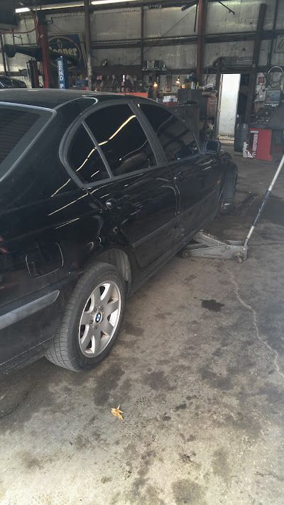 A black car is parked in a garage.