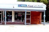 Frank's Market storefront with Pepsi sign, open door, and boarded-up section.