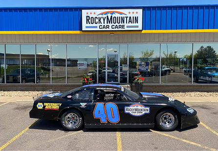 Black race car with number 40 in front of Rocky Mountain Car Care building. | Rocky Mountain Car Care