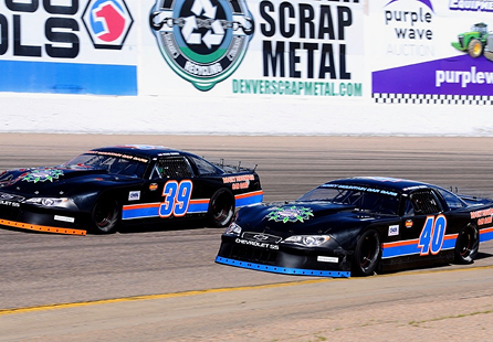 Two black race cars, numbers 39 and 40, racing on a track. | Rocky Mountain Car Care
