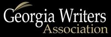 Logo for the Georgia Writers Association, featuring text on a black background with a stylized gold leaf design.