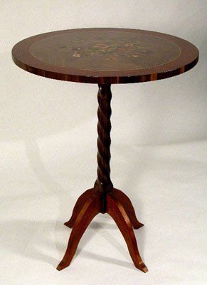 Walnut and Mahogany pedestal table with marquetry top.