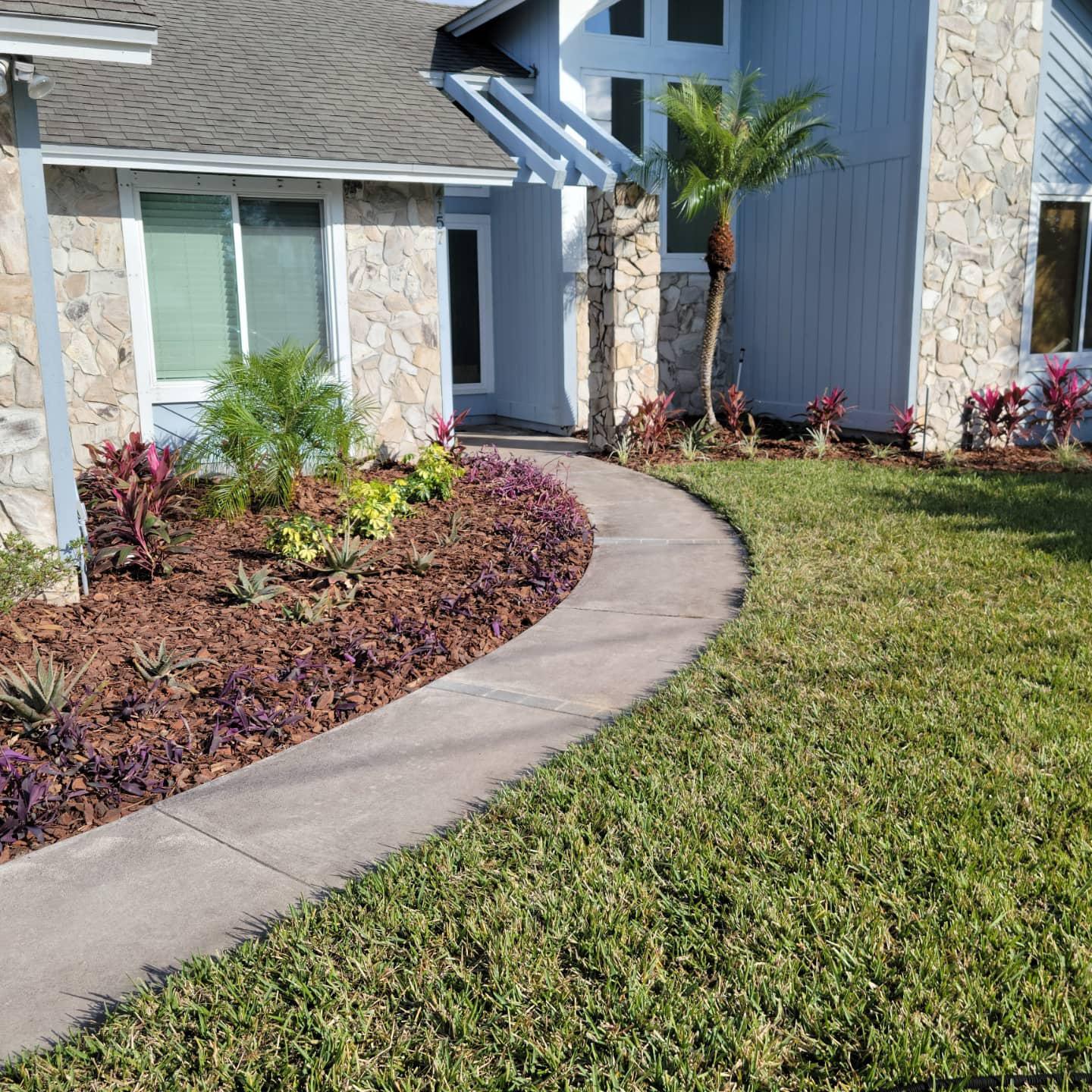A house with a concrete walkway leading to it