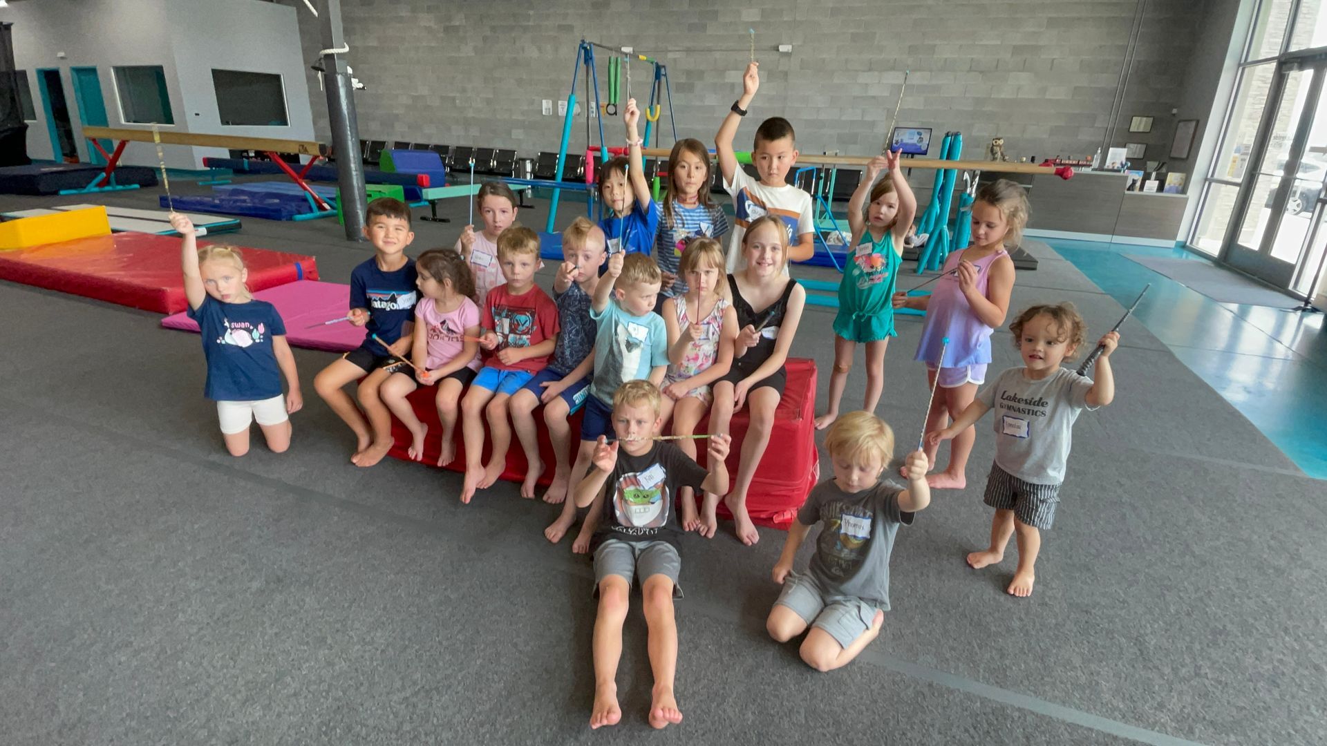 A group of children are posing for a picture in a gym.