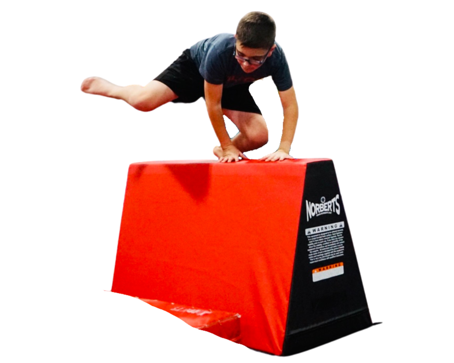 A young boy is doing a handstand on a red and black box.