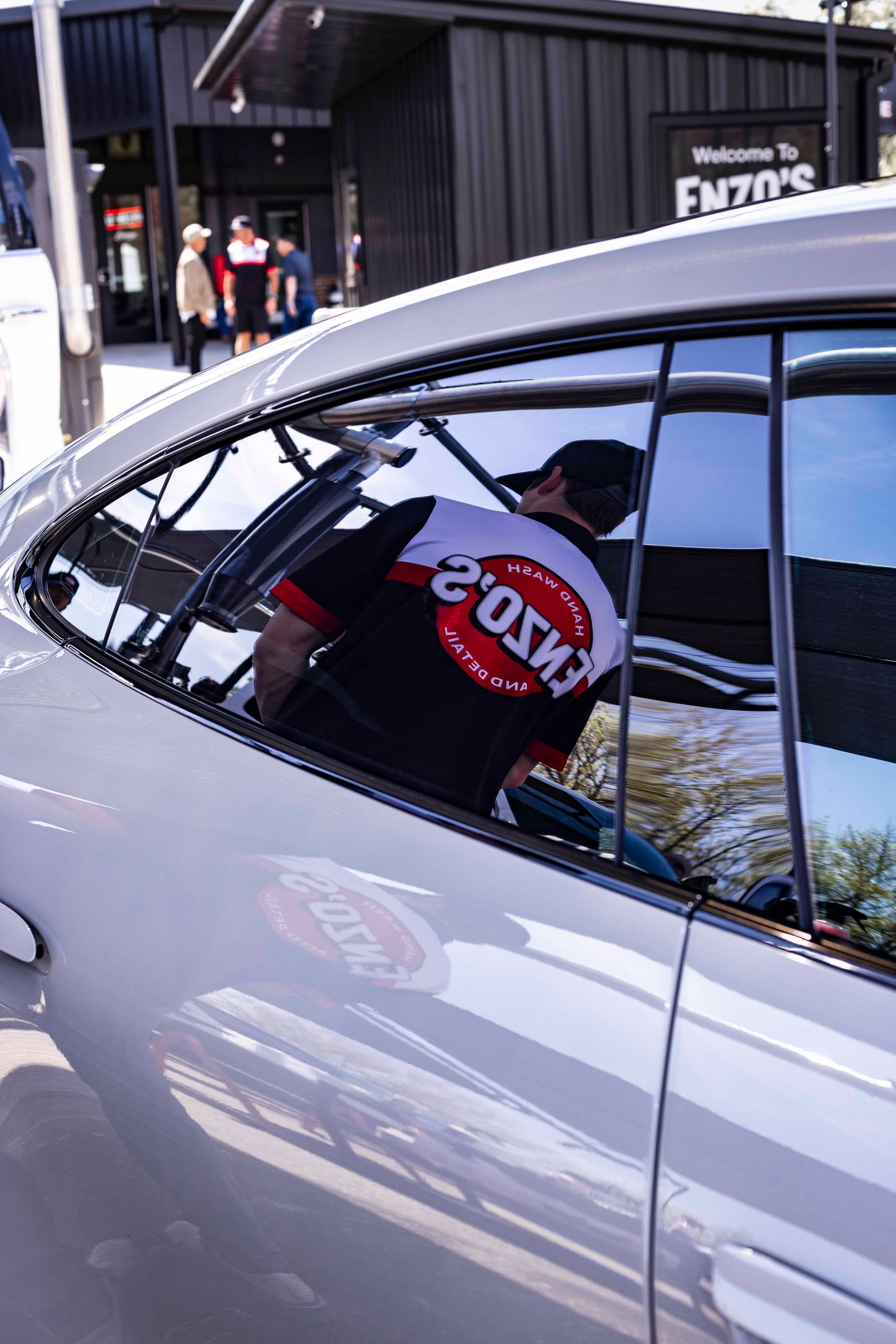 A person inside a white car wearing a 