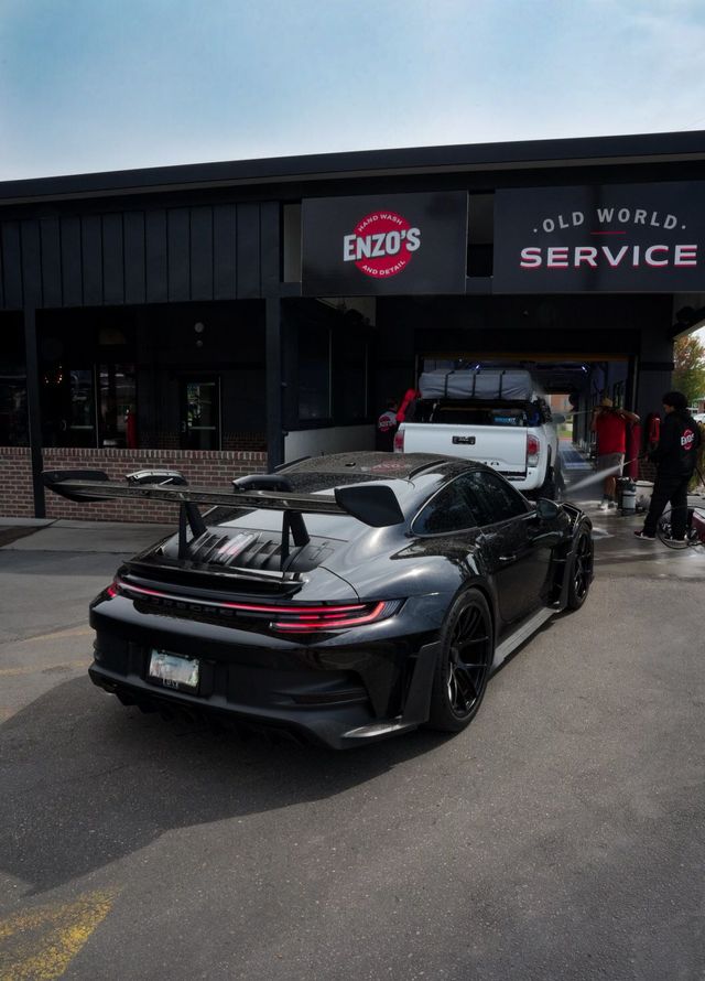 Black Porsche sports car parked outside