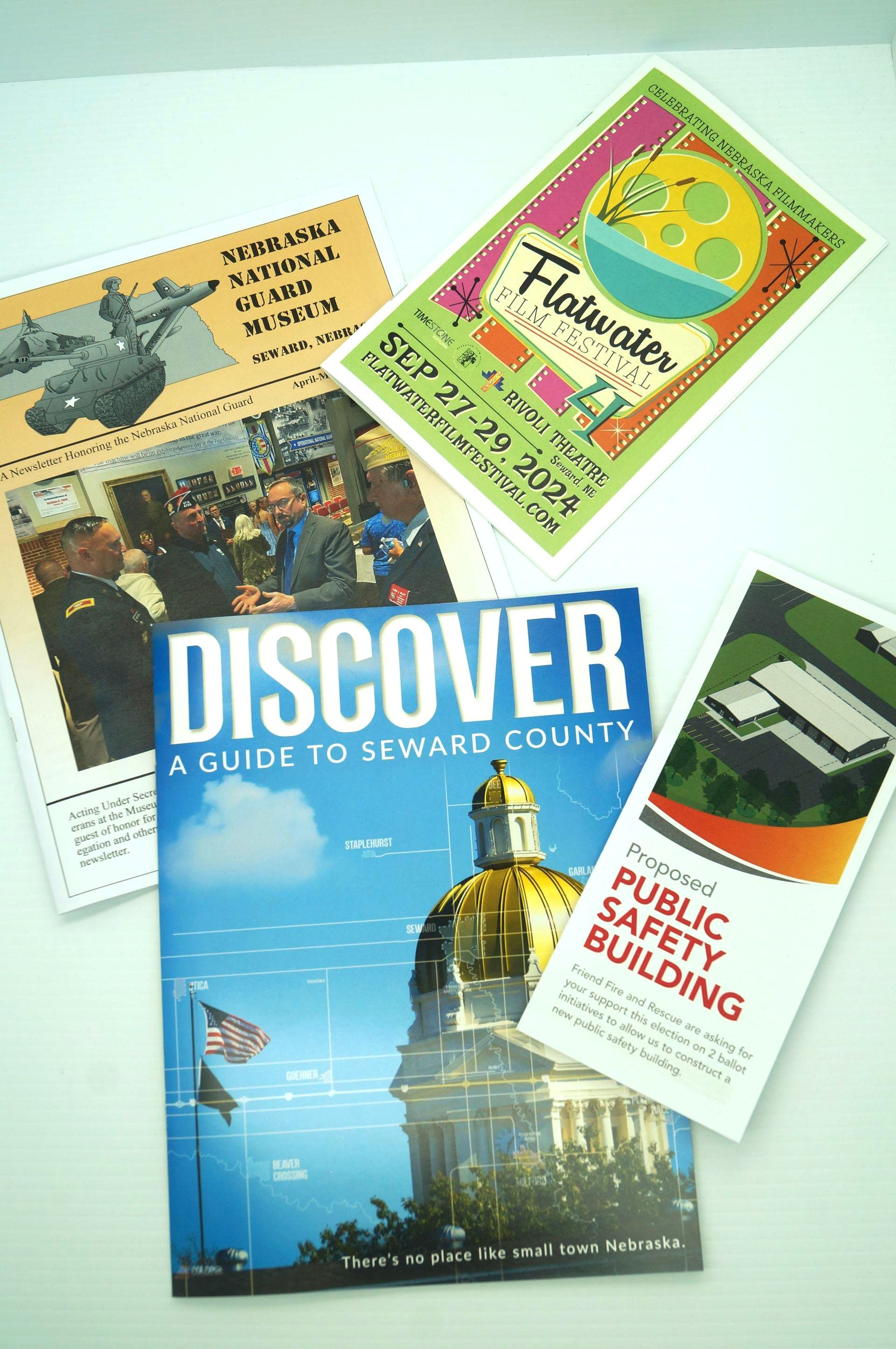 A book called discover is sitting on top of a table with other books.