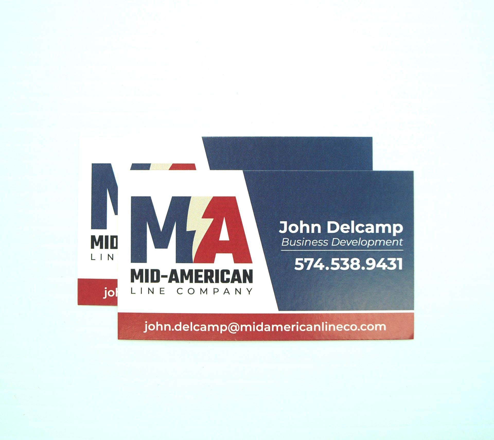 A business card with the name john delcamp on it